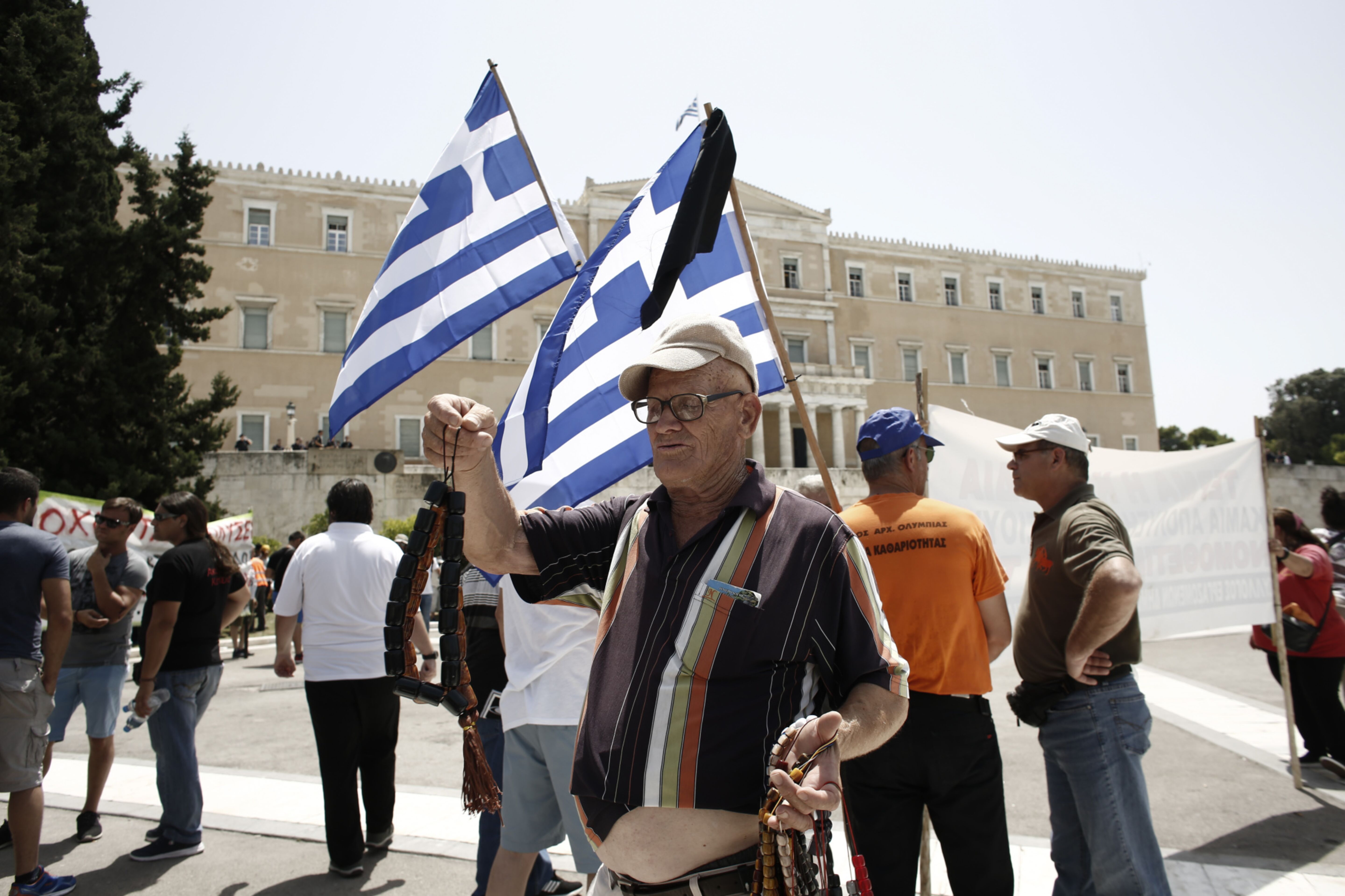 A street vendor looks for customers during a demonstration outside the Greek parliament in 2017. Greece was the epicenter of the European financial crisis.